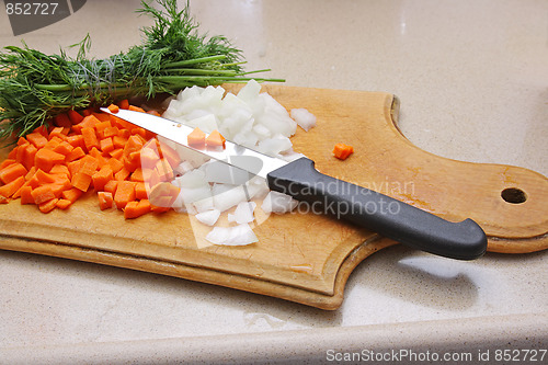 Image of Cutting onion on the wooden board