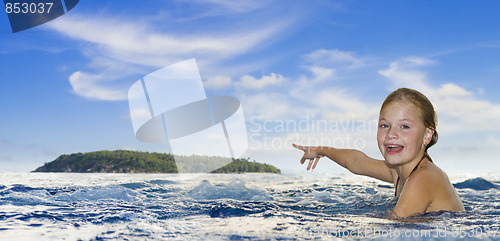 Image of girl in the sea pointing to an island