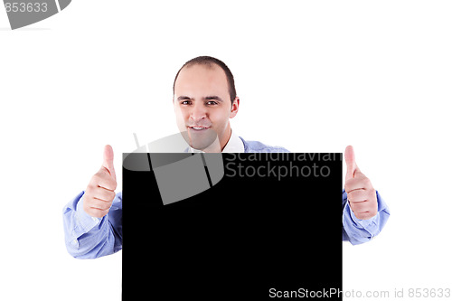 Image of Young businessman holding a blackboard displaying the sign of success