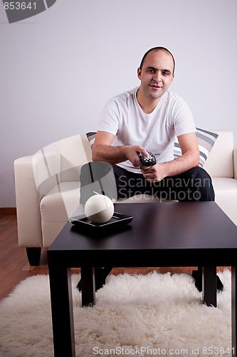 Image of casual man watching tv on sofa