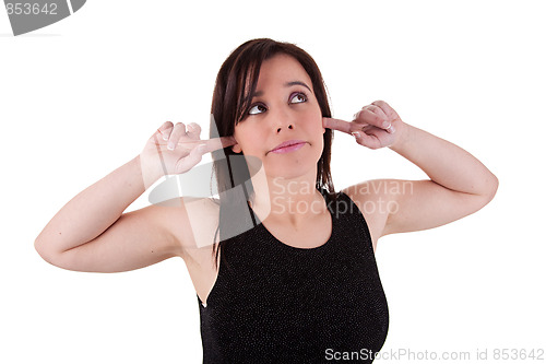 Image of Young man, holding fingers in his ears, bored