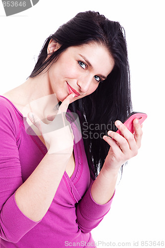 Image of beautiful young woman on the phone, smiling at the camera with one finger to touch the mouth