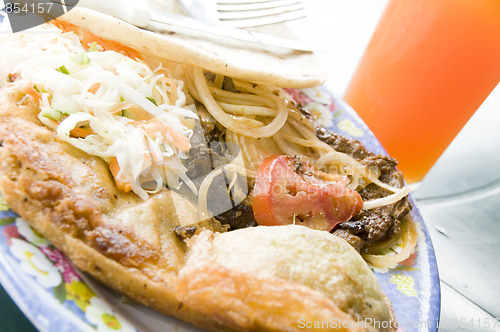 Image of plate of street food with fresh mango juice leon nicaragua