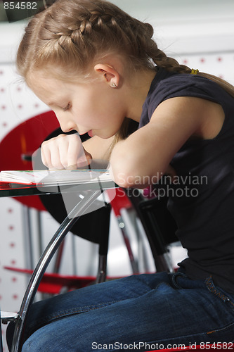 Image of Girl bending over book