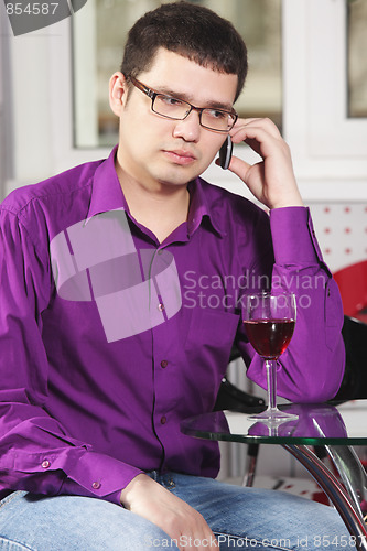 Image of Sad guy in cafe with cellphone