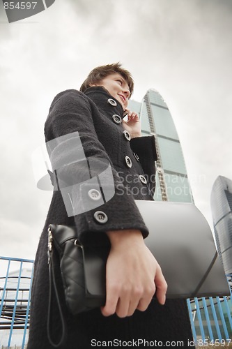 Image of Smiling businesswoman in city