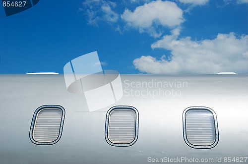 Image of Closed windows on gray metallic corporate jet