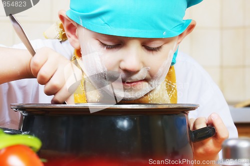Image of Little cook looking into pan