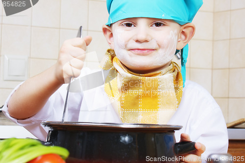 Image of Little smiling cook steering