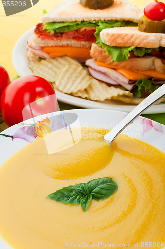 Image of Yellow soup and sandwich