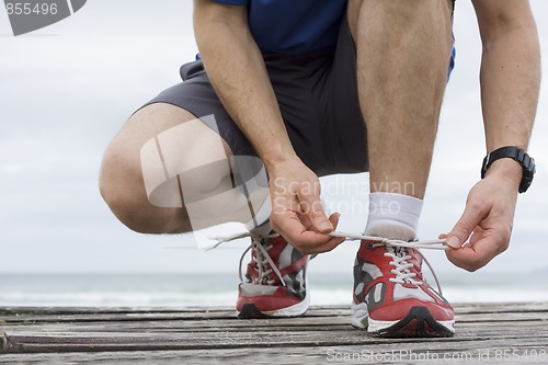 Image of Runner tying shoelace