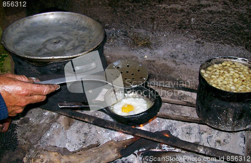 Image of Cooking Woman in A Hut