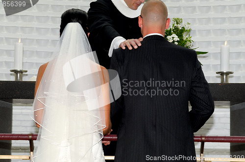 Image of Bride and groom and prist
