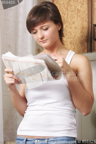 Image of Woman reading paper