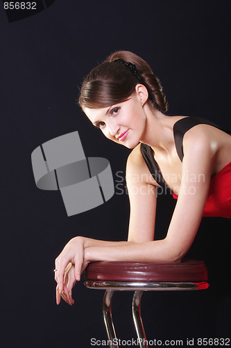 Image of Young woman leaning on chair