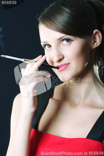 Image of Young woman with cigarette looking up