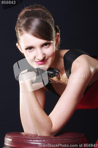 Image of Positive young woman leaning on chair