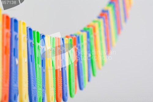 Image of Many colorful clothe pegs in a row
