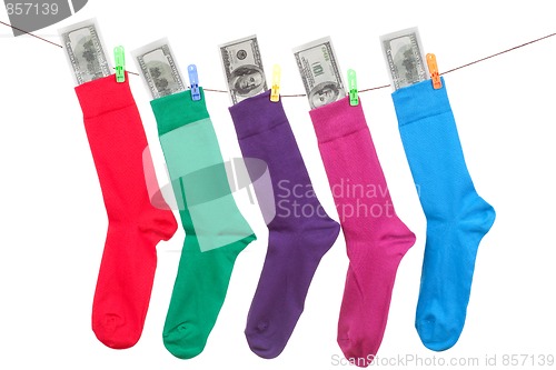 Image of colorful socks with cash hang on rope