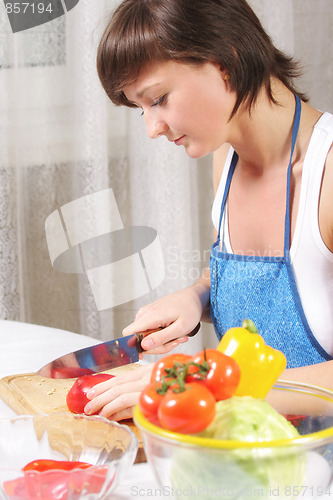 Image of Woman cutting paprika sideview