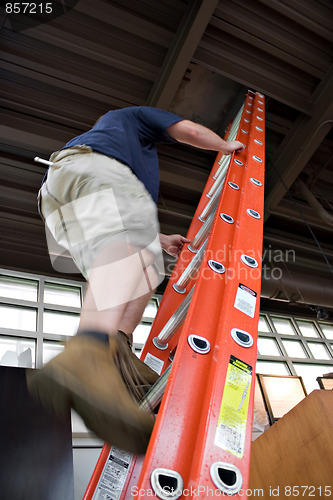 Image of Man Climbing a Ladder