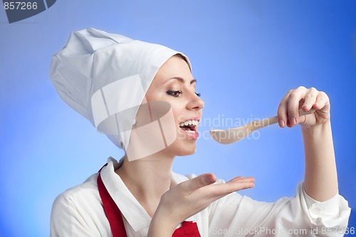 Image of Cook tasting using wood spoon