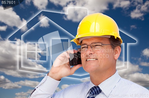 Image of Contractor in Hardhat on Phone Over House Icon and Blurry Clouds