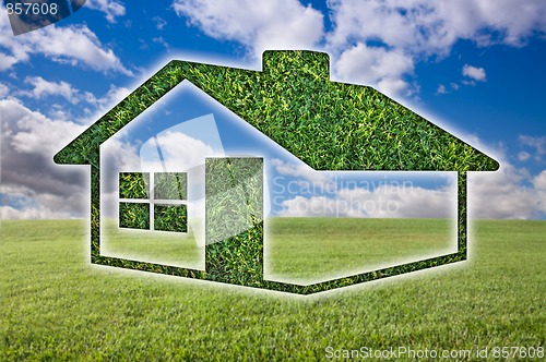 Image of Green Grass House Icon Over Field, Sky and Clouds