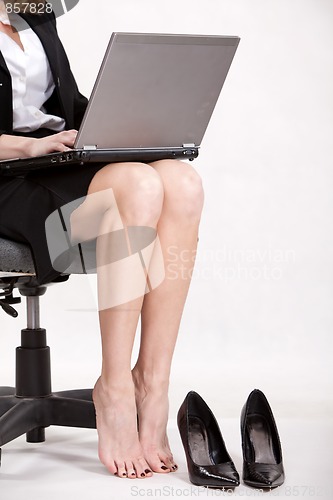 Image of Businesswoman legs with laptop