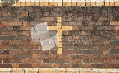 Image of christian cross in brick wall