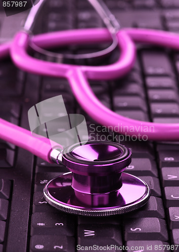Image of pink stethoscope on keyboard