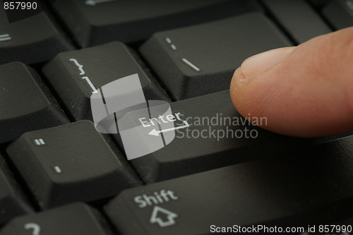 Image of finger pressing keyboard