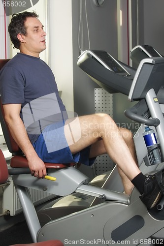 Image of Man at workout on bicycle machine