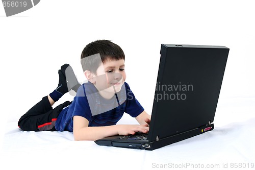 Image of small boy with a laptop on a white background