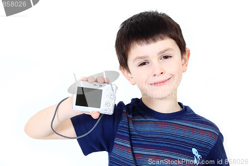 Image of small boy with digital camera on white background