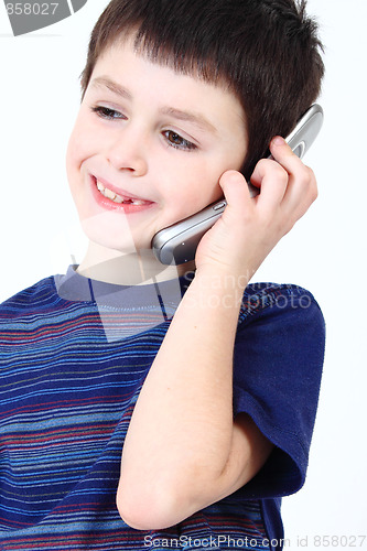 Image of Smiling small boy calling from mobile phone