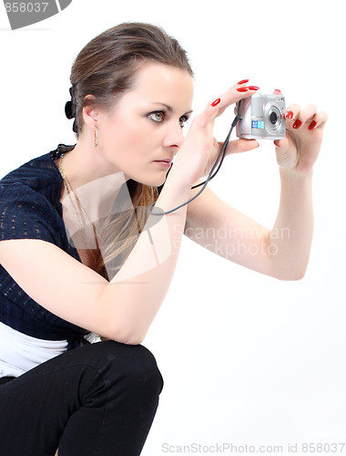 Image of The attractive woman with digital camera on white background 