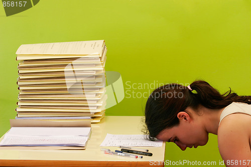 Image of woman has stress because of huge work on her desk