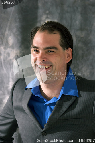 Image of man in suit laughing