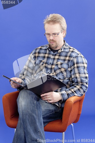 Image of Man reads business papers