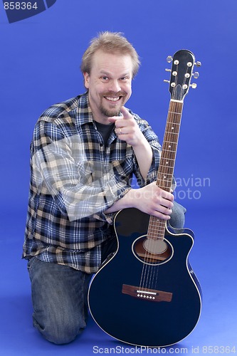 Image of Portrait Of A Smiling Man With Guitar
