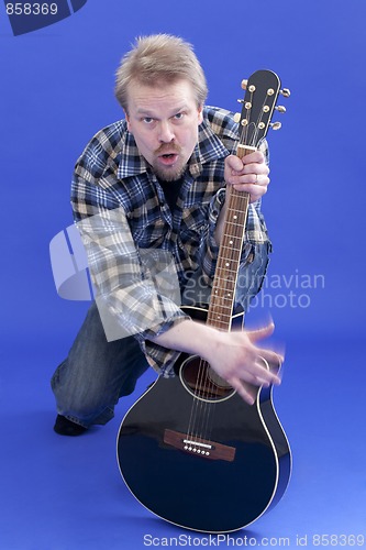 Image of Man plays guitar