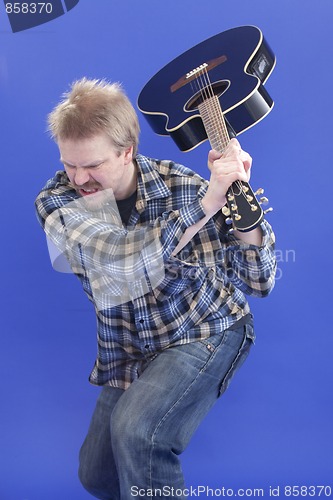 Image of Man Is Smashing His Guitar On The Floor