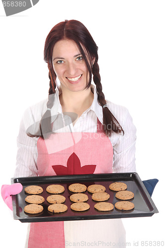 Image of beautiful housewife showing off cakes 