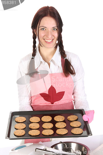 Image of beautiful housewife showing off cakes 