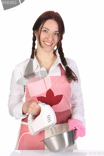 Image of beautiful housewife preparing with kitchen mixer 