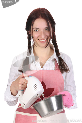 Image of beautiful housewife preparing with kitchen mixer 