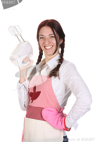 Image of beautiful housewife with electric beater 