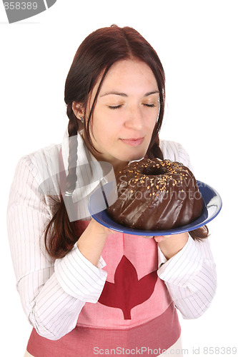 Image of beautiful housewife smelling bundt cake