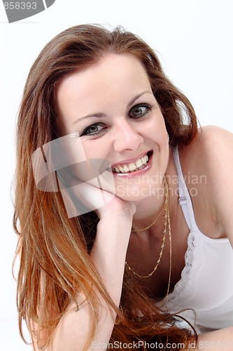 Image of Lying and smiling attractive woman 